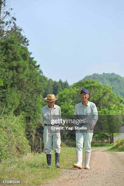 the man of two farmers walking,smiling,japan - toyooka stock pictures, royalty-free photos & images