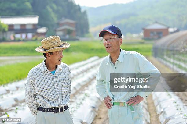 the man of two farmers talking,smiling,japan - toyooka stock pictures, royalty-free photos & images