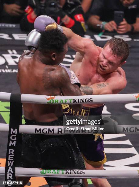 Canelo Alvarez throws a right at Jermell Charlo in the seventh round of their super middleweight title fight at T-Mobile Arena on September 30, 2023...