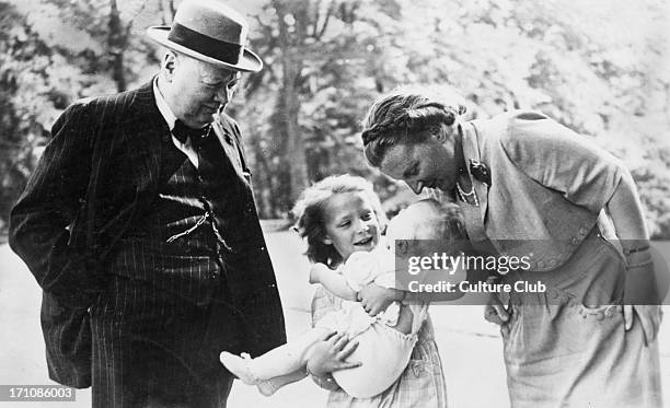 British former Prime Minister Winston Churchill and Queen Juliana of the Netherlands look on as Juliana's daughter Irene holds her baby sister...