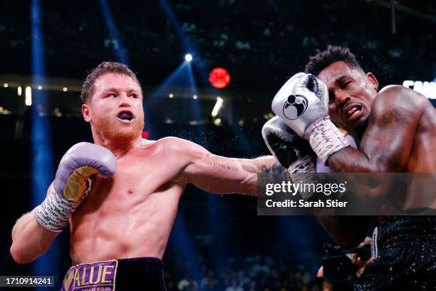 Saul "Canelo" Alvarez of Mexico trades punches with Jermell Charlo during their super middleweight title fight at T-Mobile Arena on September 30,...