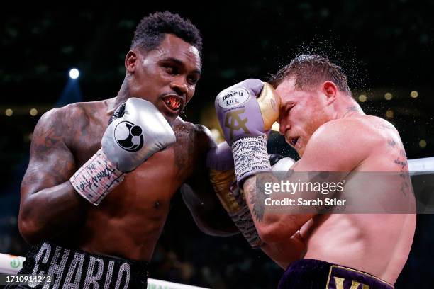 Saul "Canelo" Alvarez of Mexico trades punches with Jermell Charlo during their super middleweight title fight at T-Mobile Arena on September 30,...