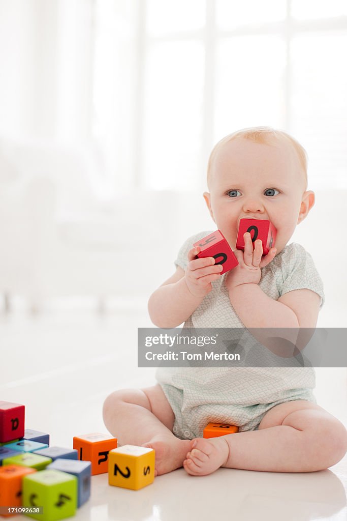 Baby biting wood block