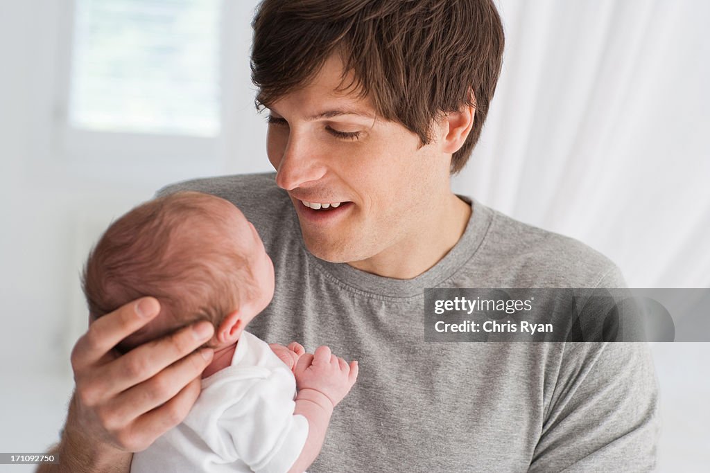 Smiling father holding baby