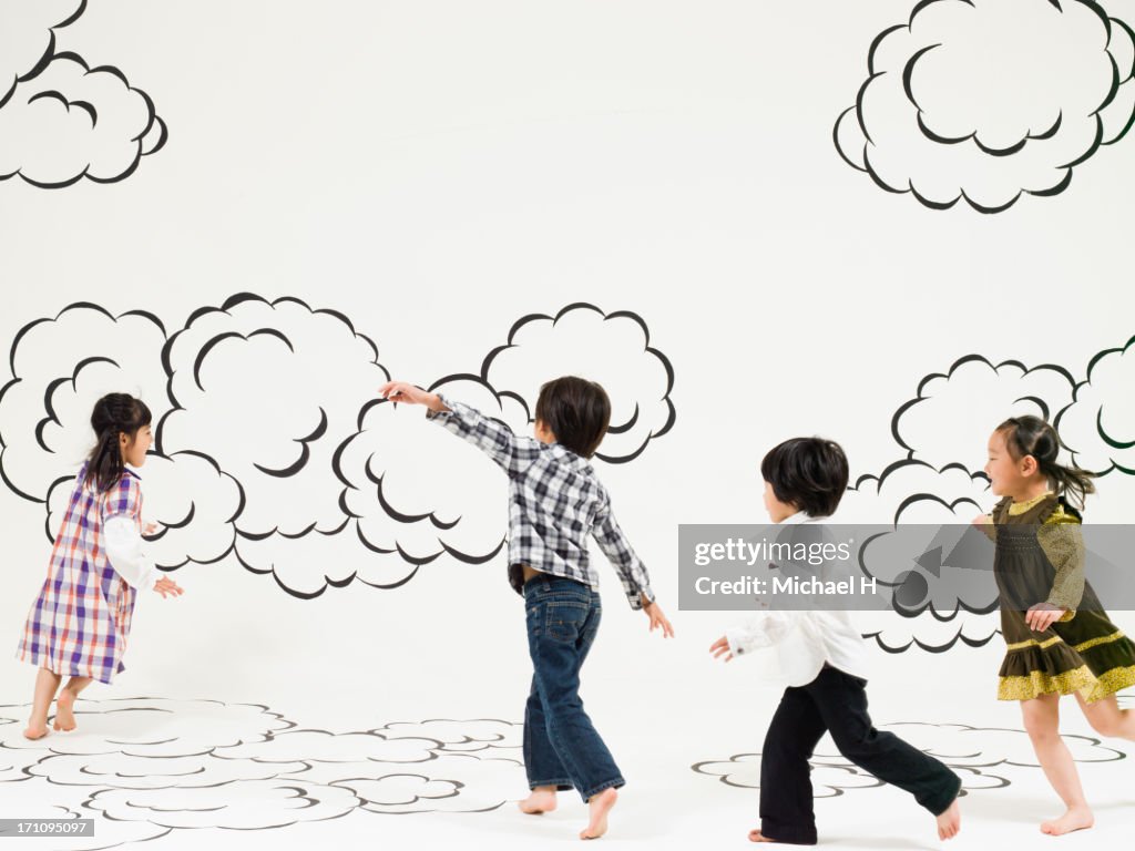 Children running on the clouds