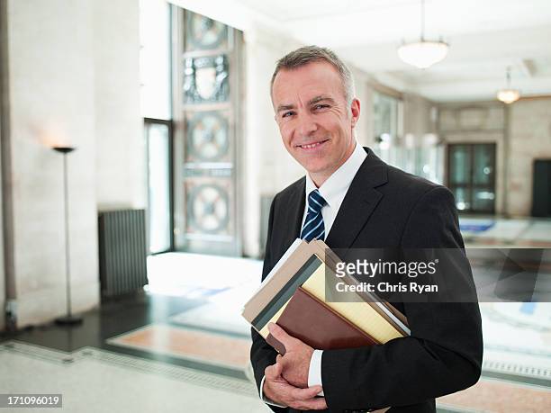 smiling lawyer in lobby - lawyer courthouse stock pictures, royalty-free photos & images