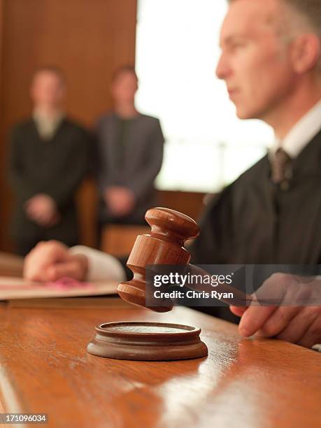 judge holding gavel in courtroom - the three trials of oscar wilde after party stockfoto's en -beelden