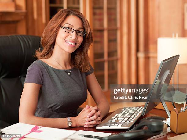 smiling lawyer sitting at laptop in office - secretary 個照片及圖片檔