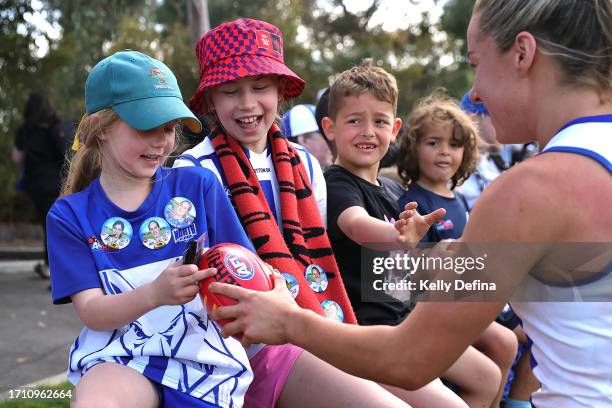 Alice O'Loughlin of the Kangaroos thanks fans with mini footballs during the round five AFLW match between North Melbourne Tasmania Kangaroos and...