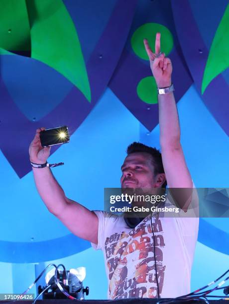 Producer/DJ ATB takes a photo during his performance at the 17th annual Electric Daisy Carnival at Las Vegas Motor Speedway on June 21, 2013 in Las...