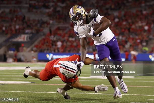 Wide receiver Germie Bernard of the Washington Huskies makes a reception past safety Isaiah Taylor of the Arizona Wildcats during the second half of...