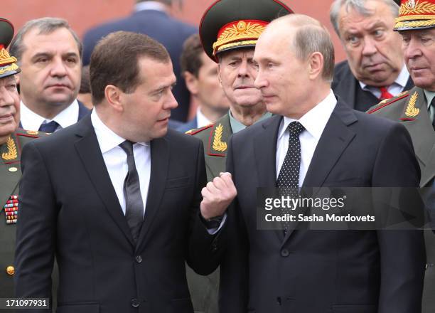 Russian President Vladimir Putin and Prime Minister Dmitry Medvedev attend a wreath laying ceremony at the Tomb of the Unknown Soldier in Alexander...