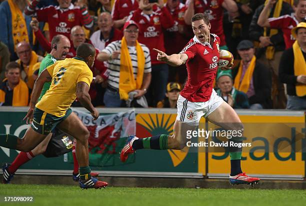 George North of the Lions taunts Will Genia as he breaks clear to score the first Lions try during the First Test match between the Australian...