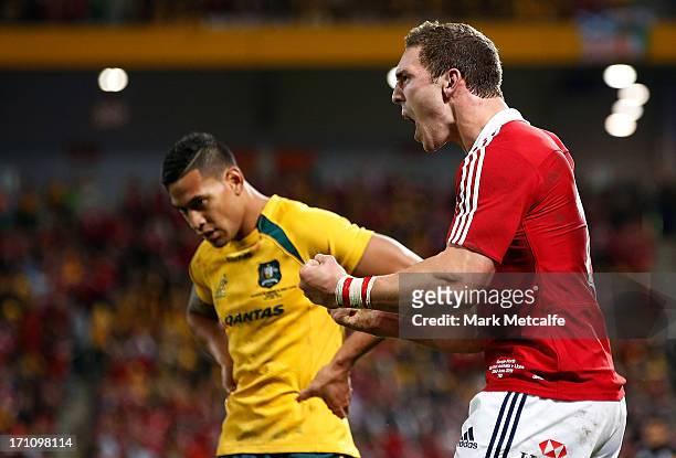George North of the Lions celebrates scoring a try as Israel Folau of the Wallabies looks dejected during the First Test match between the Australian...