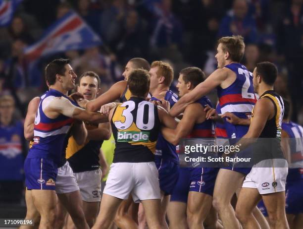 Players wrestle as they leave the ground at half time during the round 13 AFL match between the Western Bulldogs and the Richmond Tigers at Etihad...