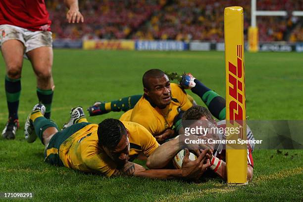 Israel Folau of the Wallabies tackles George North of the Lions as he attempts to score a try unsuccessfully during the First Test match between the...