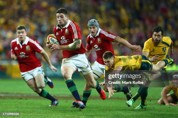 Alex Cuthbert of the Lions makes a break on his way to scoring a try during the First Test match between the Australian Wallabies and the British &...