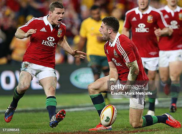 Alex Cuthbert of the Lions celebrates scoring a try with teammate Brian O'Driscoll during the First Test match between the Australian Wallabies and...