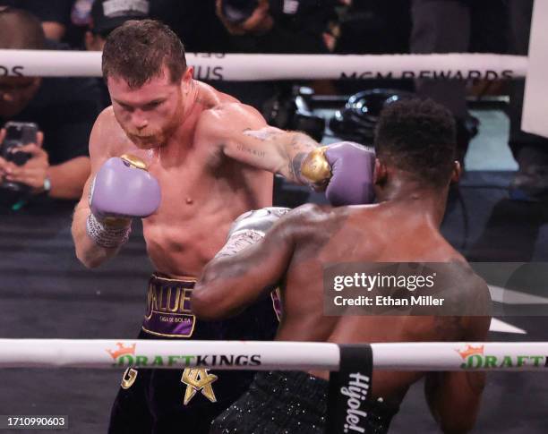 Canelo Alvarez hits Jermell Charlo in the fifth round of their super middleweight title fight at T-Mobile Arena on September 30, 2023 in Las Vegas,...