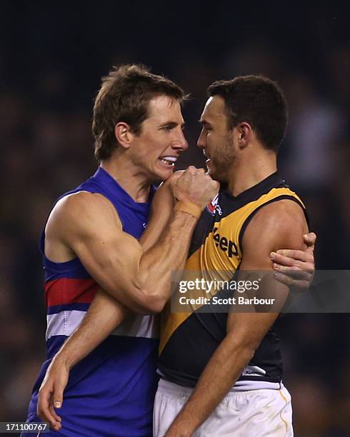 Dale Morris of the Bulldogs and Shane Edwards of the Tigers wrestle during the round 13 AFL match between the Western Bulldogs and the Richmond...