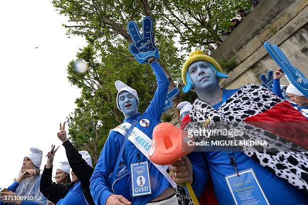 People dressed as smurfs pose during a flashmob leaded by choreographers of French TV show 'Danse avec les Stars' , during the 2nd edition of the...