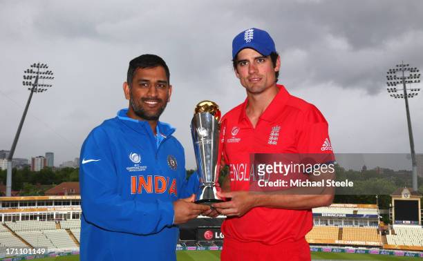 Dhoni captain of India poses with the ICC Champions Trophy alongside Alastair Cook captain of England at Edgbaston on June 22, 2013 in Birmingham,...