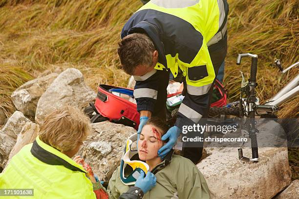 emergency response team attending injured woman - emergency response stock pictures, royalty-free photos & images