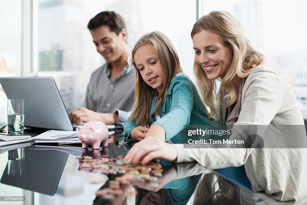 Mother and daughter counting coins