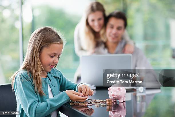 niña con padres recuento de monedas en el fondo - compito a casa fotografías e imágenes de stock