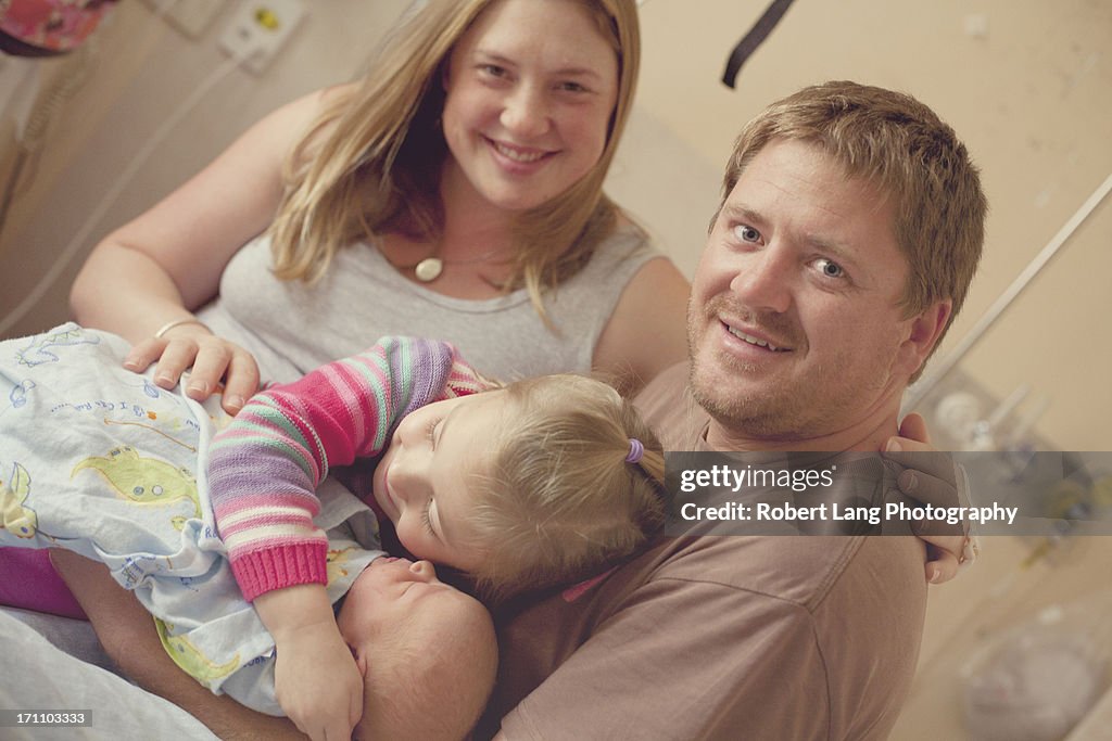 Family all together with new born baby in hospital