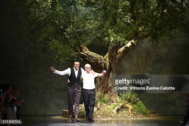 Designers Stefano Gabbana and Domenico Dolce acknowledge the applause of the audience after the Dolce & Gabbana show during Milan Menswear Fashion...