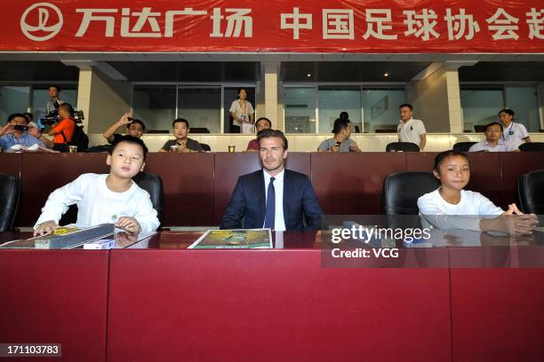 David Beckham watches from the stand during the Chinese Super League between Hangzhou Greentown and Beijing Guoan at Yellow Dragon Sports Center on...