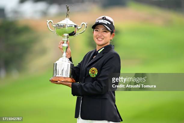 Erika Hara of Japan poses with the trophy after winning the tournament following the final round of the Japan Women's Open Golf Championship at Awara...