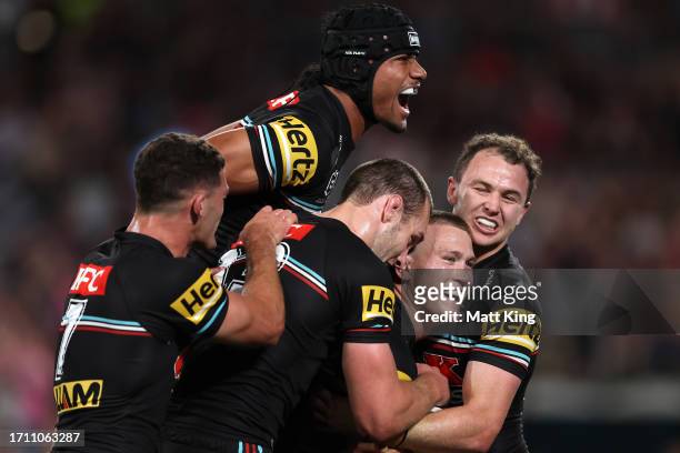 Mitch Kenny of the Panthers celebrates with team mates after scoring a try during the 2023 NRL Grand Final match between Penrith Panthers and...