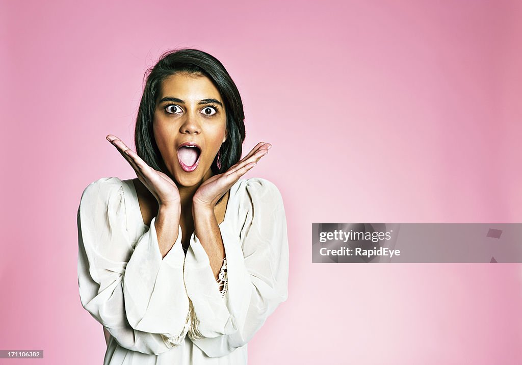 Beautiful Young Woman Gasps In Delight Or Shock Against Pink High