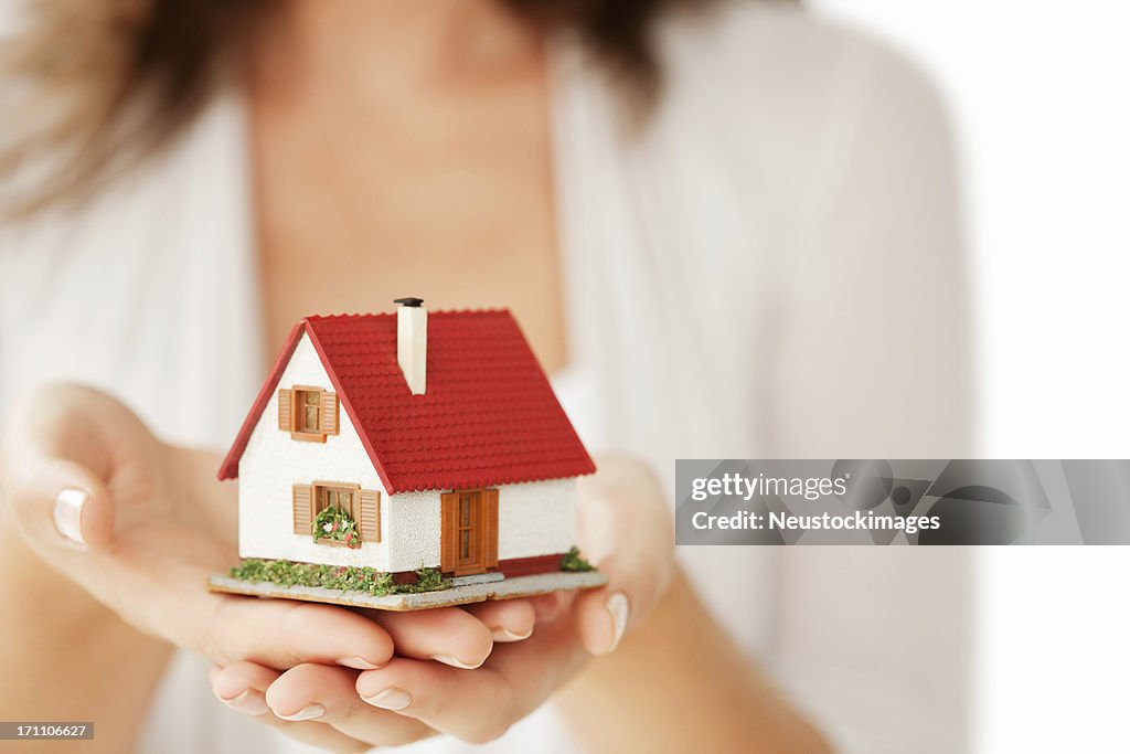 Woman's Hands Holding a Little House - Isolated