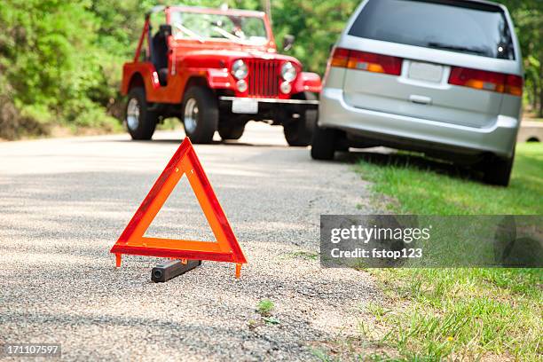 two car accident with focus on orange triangle warning sign. - emergency sign stock pictures, royalty-free photos & images