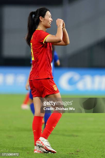 Yang Lina of China celebrates her second goal during the 19th Asian Games Women's Quarterfinal match between China and Thailand at Linping Sports...