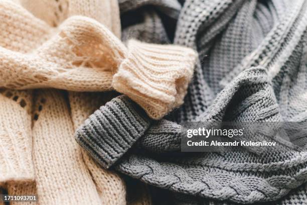 knitted warm grey and beige sweaters or scarf. fabric knitted texture close up background. - wollpullover stock-fotos und bilder
