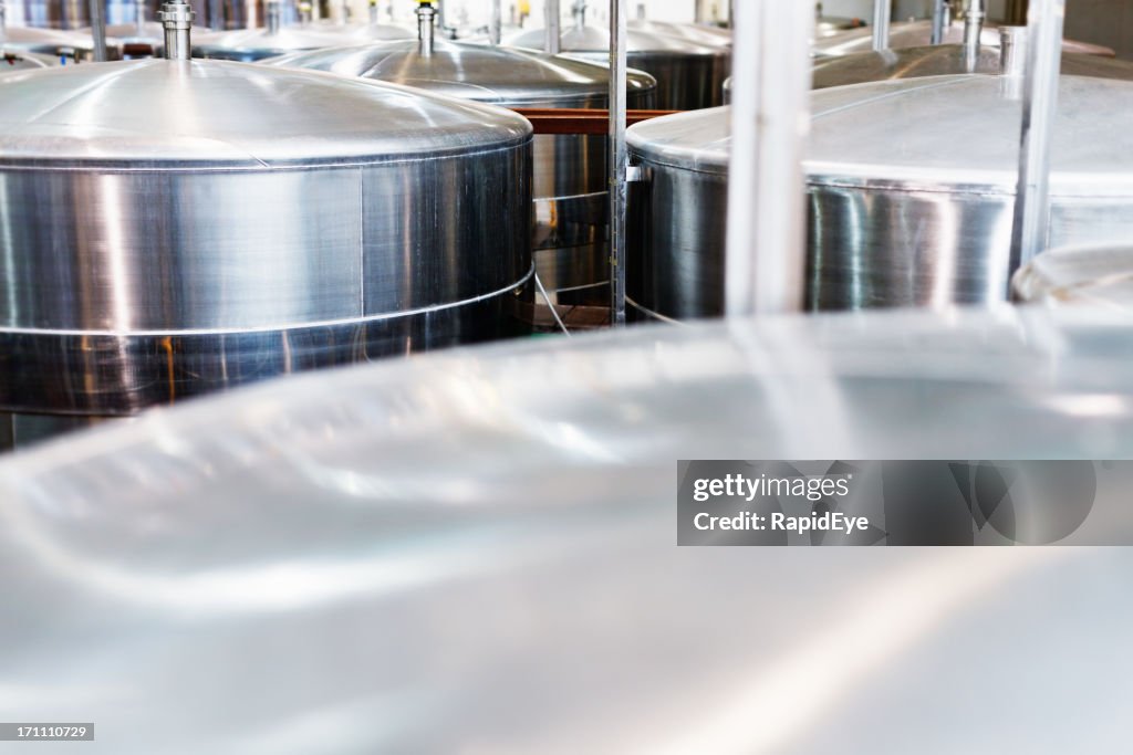 Close up of stainless steel fermentation vats at modern winery