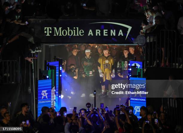 Canelo Alvarez , flanked by rappers Tornillo Vazquez and Santa Fe Klan , waits to enter the ring for his super middleweight title fight against...