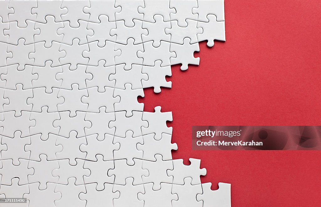 White jigsaw puzzle on a red background