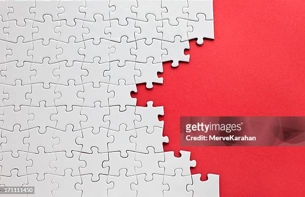 white jigsaw puzzle on a red background - pusselbit bildbanksfoton och bilder