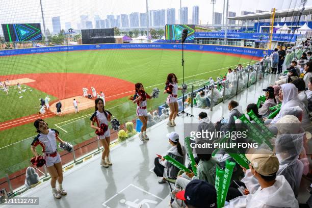 Spectators watch cheerleaders performancing at the baseball bronze medal match between Japan and China during the Hangzhou 2022 Asian Games in...