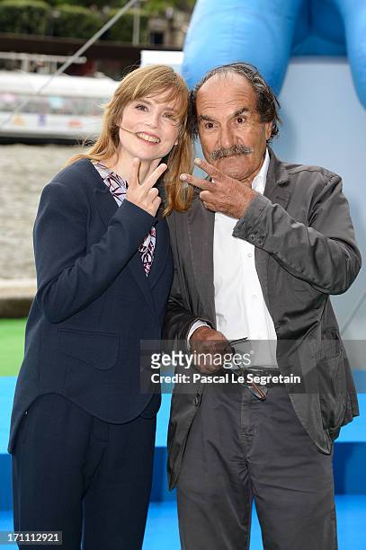 Actors Isabelle Carre and Gerard Hernandez pose as part of Global Smurfs Day celebrations on the Seine river bank on June 22, 2013 in Paris, France....