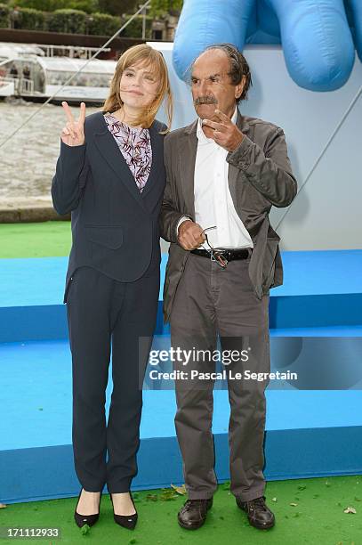 Actors Isabelle Carre and Gerard Hernandez pose as part of Global Smurfs Day celebrations on the Seine river bank on June 22, 2013 in Paris, France....