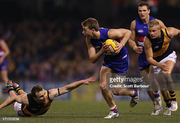 Jack Macrae of the Bulldogs runs with the ball during the round 13 AFL match between the Western Bulldogs and the Richmond Tigers at Etihad Stadium...