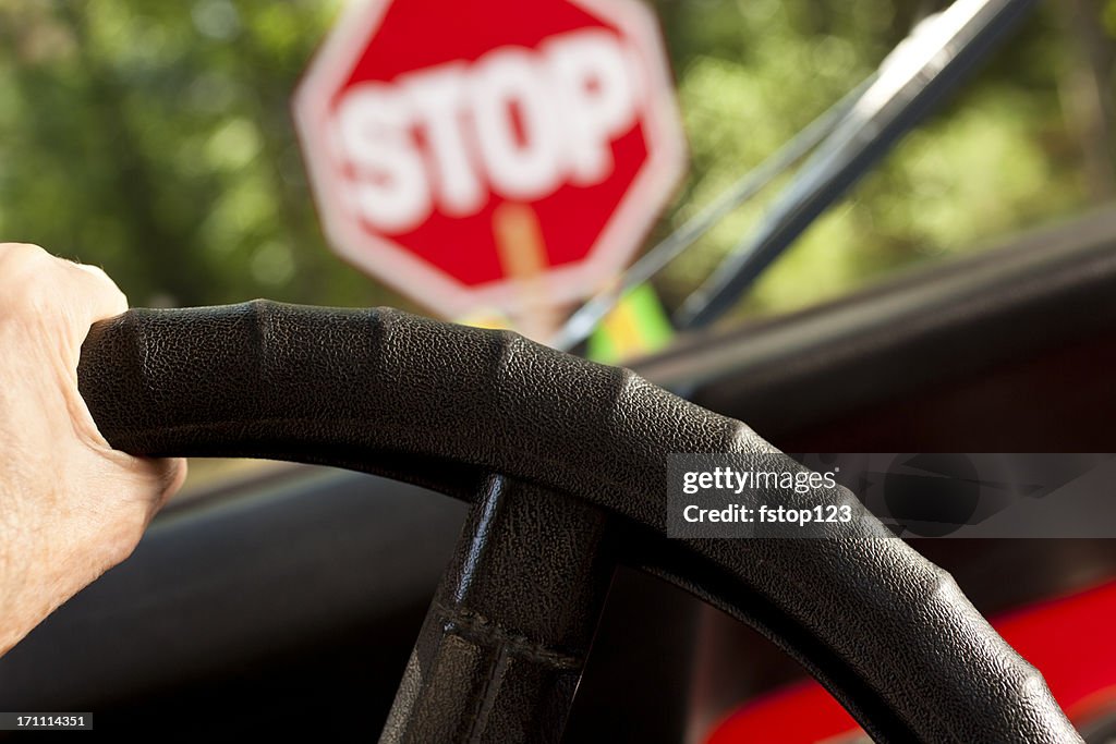 Driving car stopped at construction or school crossing stop sign.