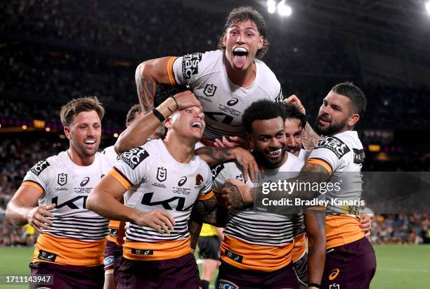Ezra Mam of the Broncos is congratulated by team mates after scoring a try during the 2023 NRL Grand Final match between Penrith Panthers and...