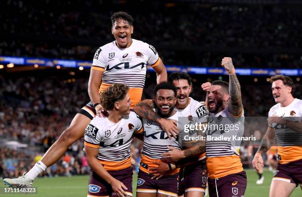 Ezra Mam of the Broncos is congratulated by team mates after scoring a try during the 2023 NRL Grand Final match between Penrith Panthers and...